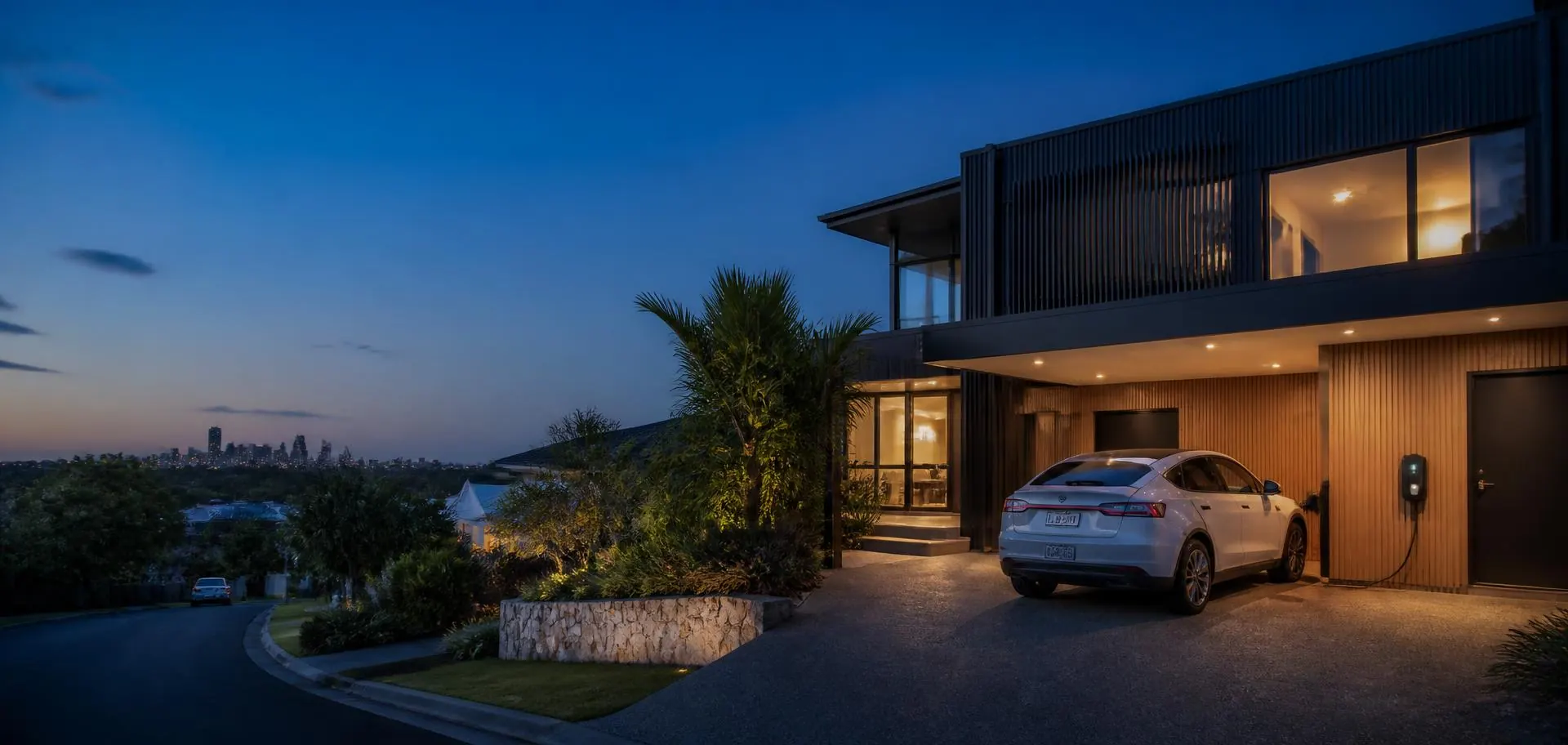 Contemporary Adelaide home at dusk with an electric car charging in the driveway
