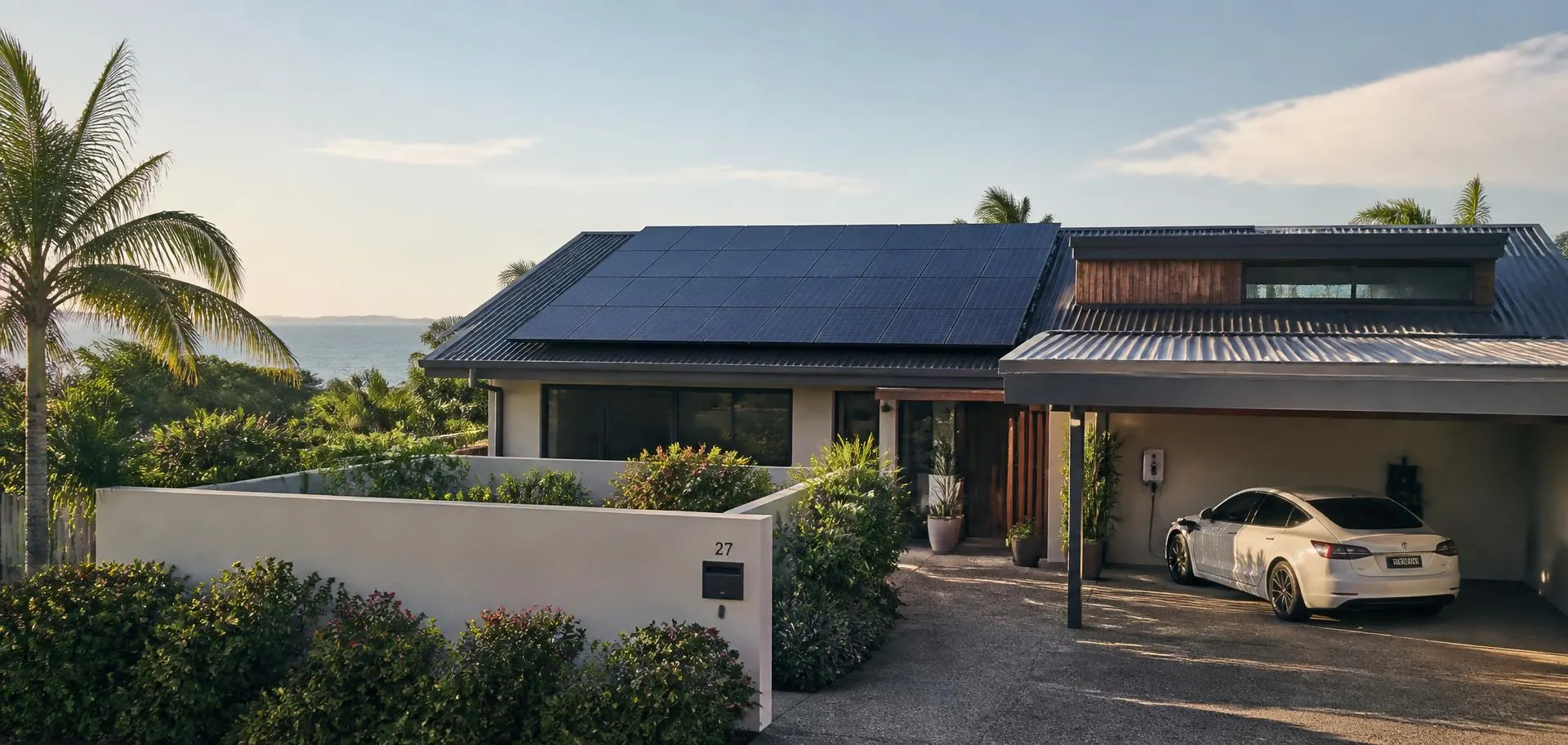 Adelaide home with rooftop solar panels and an electric car charging in the carport in afternoon light
